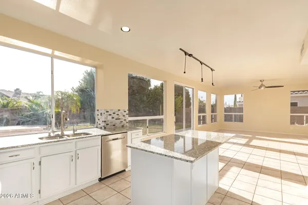 a large white kitchen with a large window