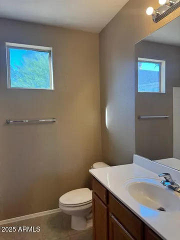 a bathroom with a sink a toilet and mirror
