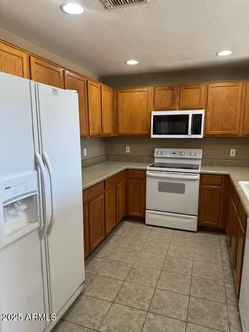a kitchen with a refrigerator sink and microwave