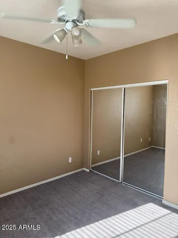 a view of an empty room with a ceiling fan