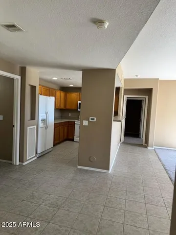 an empty room with a fireplace and windows
