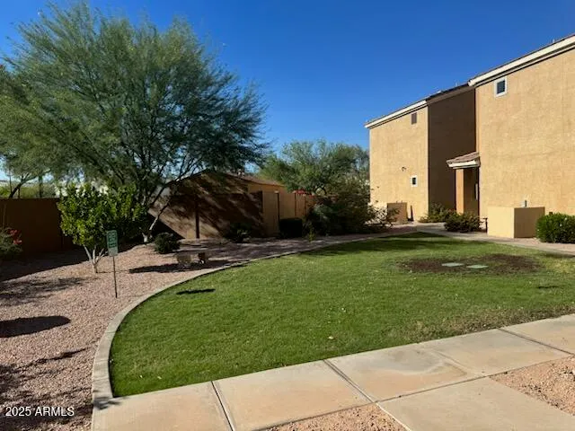a view of a backyard with sitting area