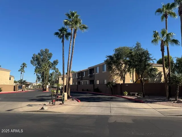 a view of a street with a cars parked on the side of road