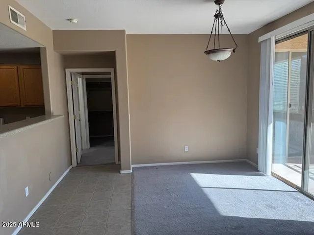 a view of a hallway with a chandelier fan