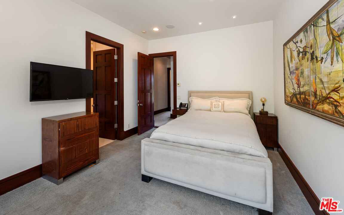 13947 Durham Road Beverly Hills, CA 90210 - Photo 12 of 15 a bed room with a bed and a television