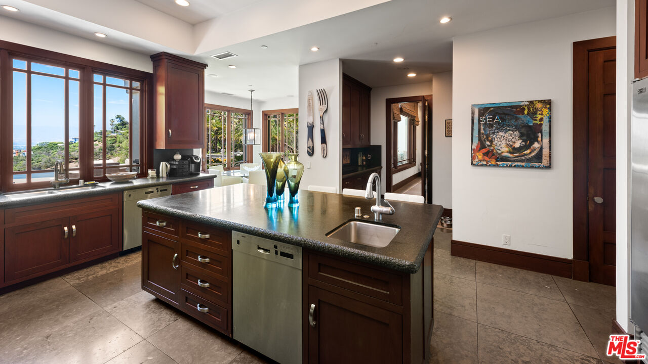 13947 Durham Road Beverly Hills, CA 90210 - Photo 14 of 15 a kitchen with a sink stove and cabinets