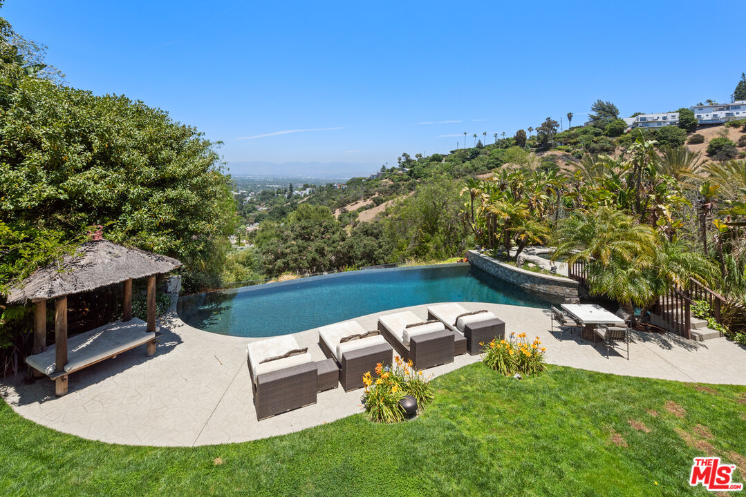 13947 Durham Road Beverly Hills, CA 90210 - Photo 15 of 15 a view of a swimming pool with a yard