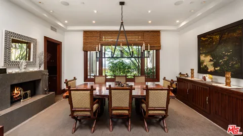 a dining room with furniture a window and a fireplace