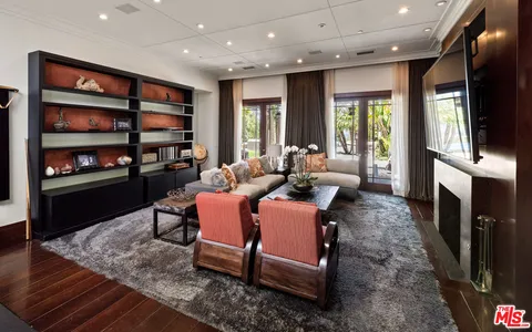 a living room with fireplace furniture and a flat screen tv