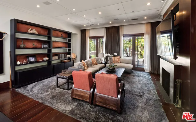 a living room with fireplace furniture and a flat screen tv