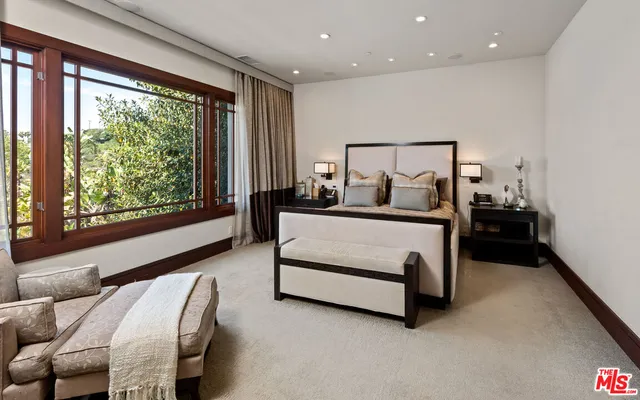 a bedroom with a bed and large window