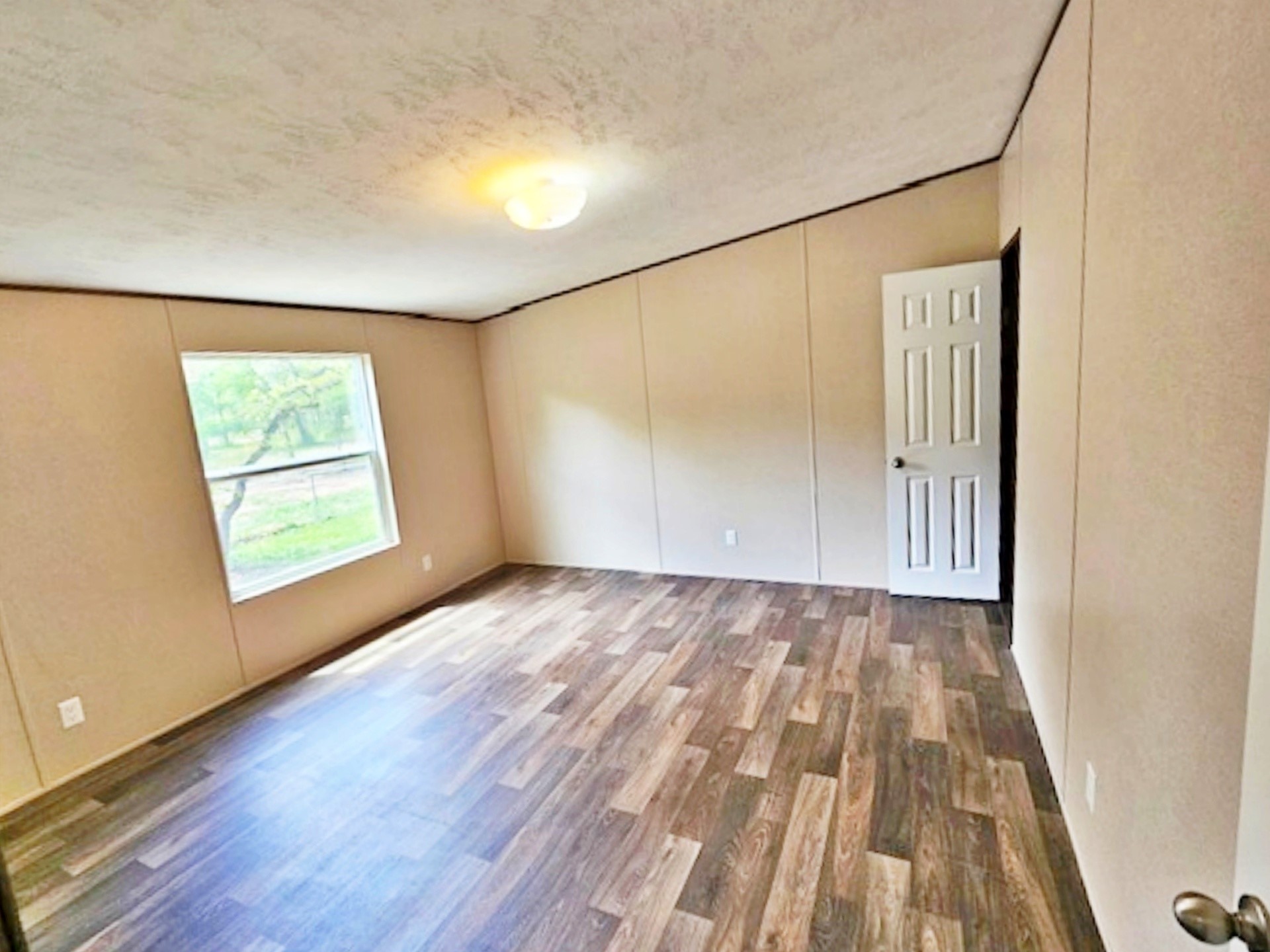 1032 Reeves Road Garwood, TX 77442 - Photo 14 of 29 an empty room with wooden floor and windows
