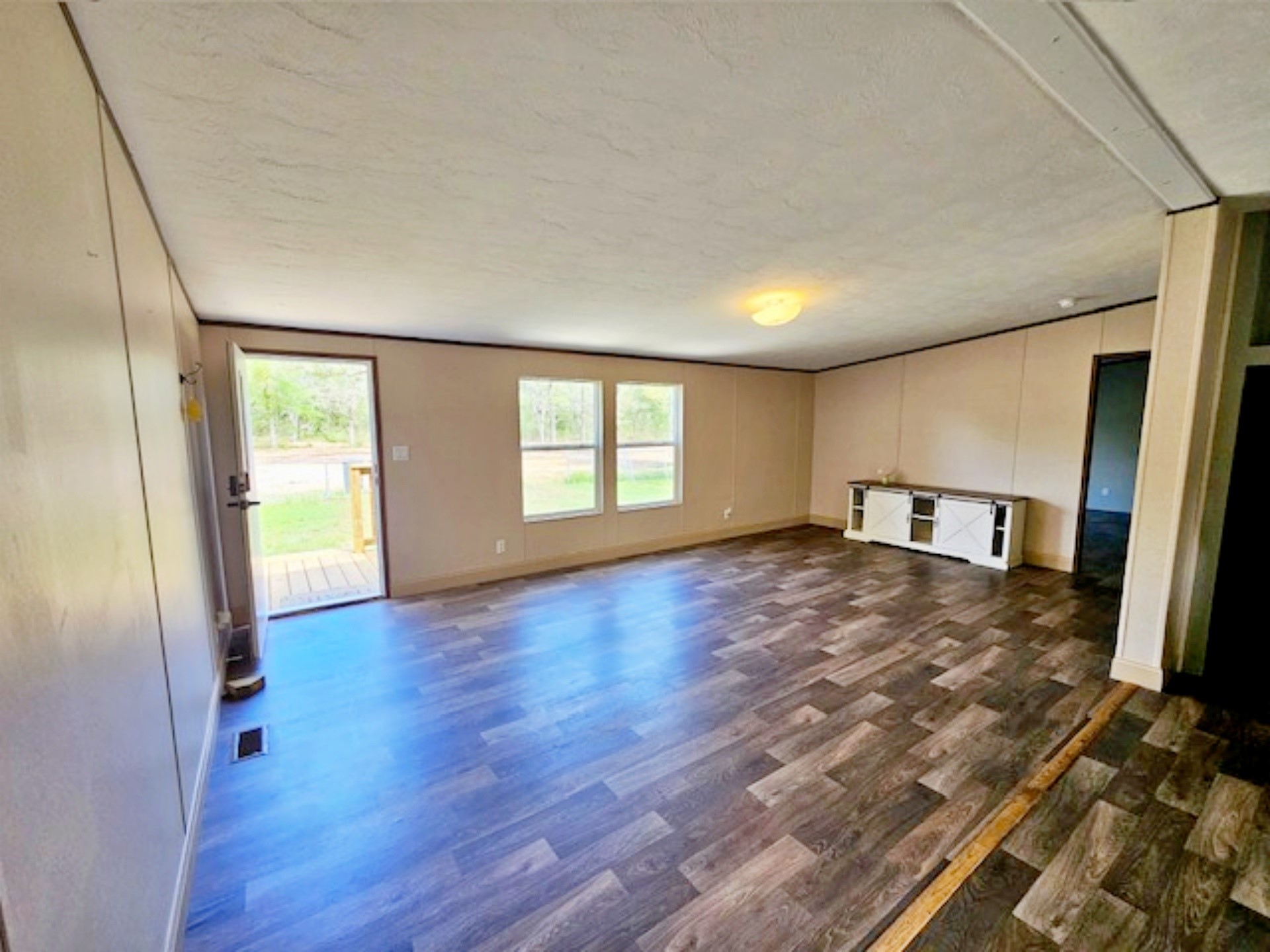 1032 Reeves Road Garwood, TX 77442 - Photo 2 of 29 a view of empty room with wooden floor and fan