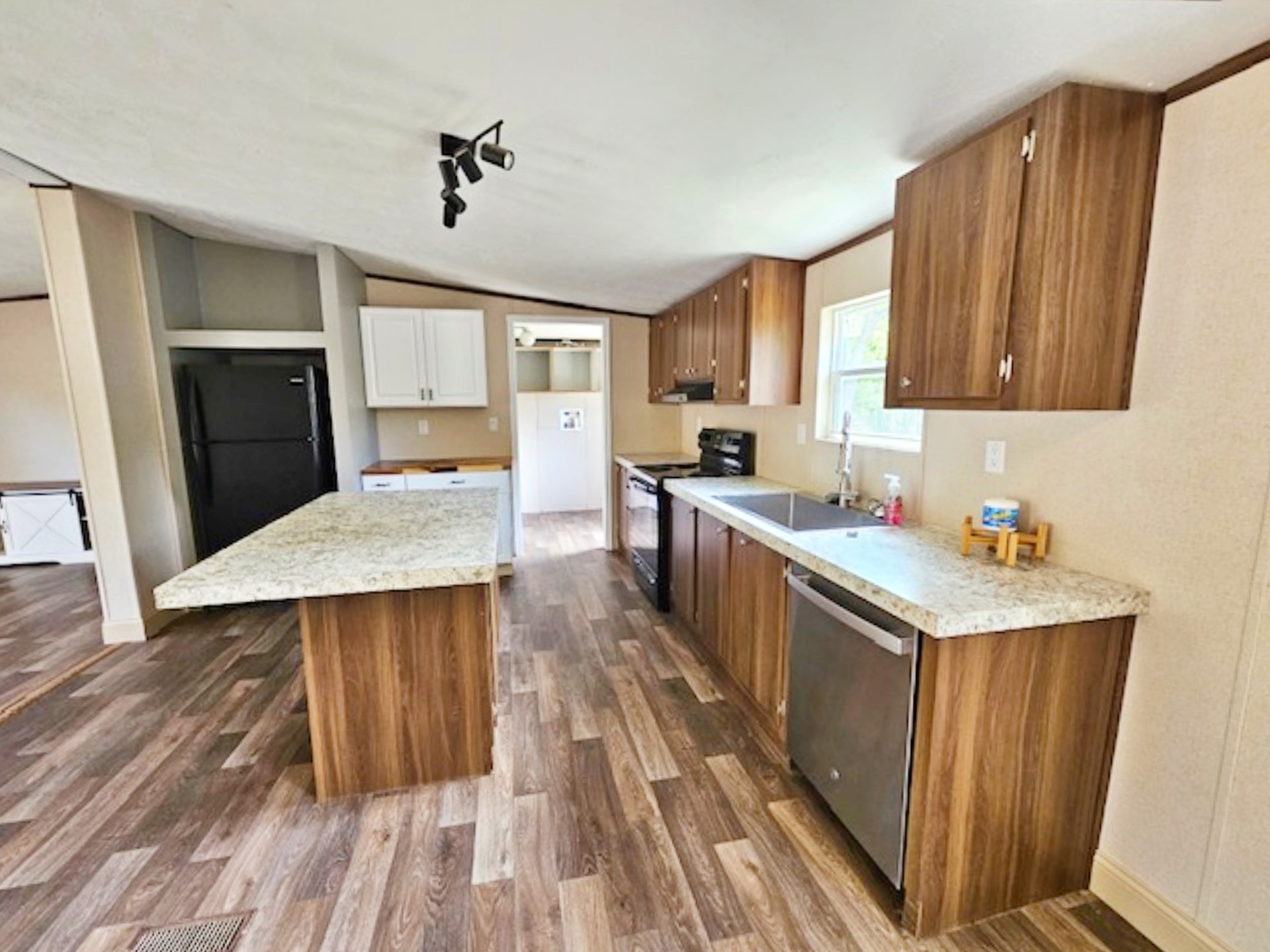 1032 Reeves Road Garwood, TX 77442 - Photo 4 of 29 a kitchen with wooden cabinets a sink a stove and a refrigerator