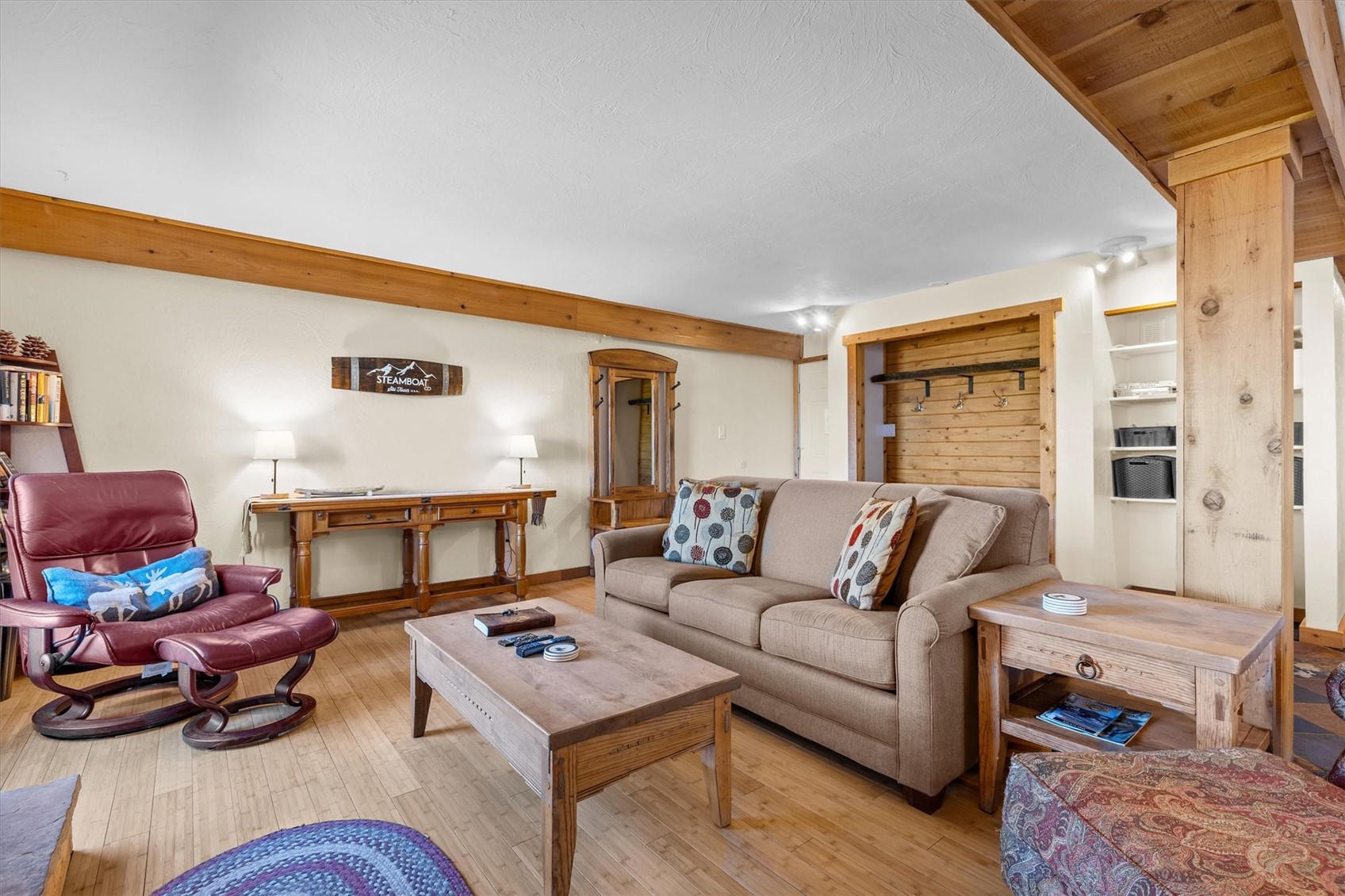 2602 Longthong Road, Unit 107 Steamboat Springs, CO 80487 - Photo 7 of 32 a living room with furniture and a fireplace