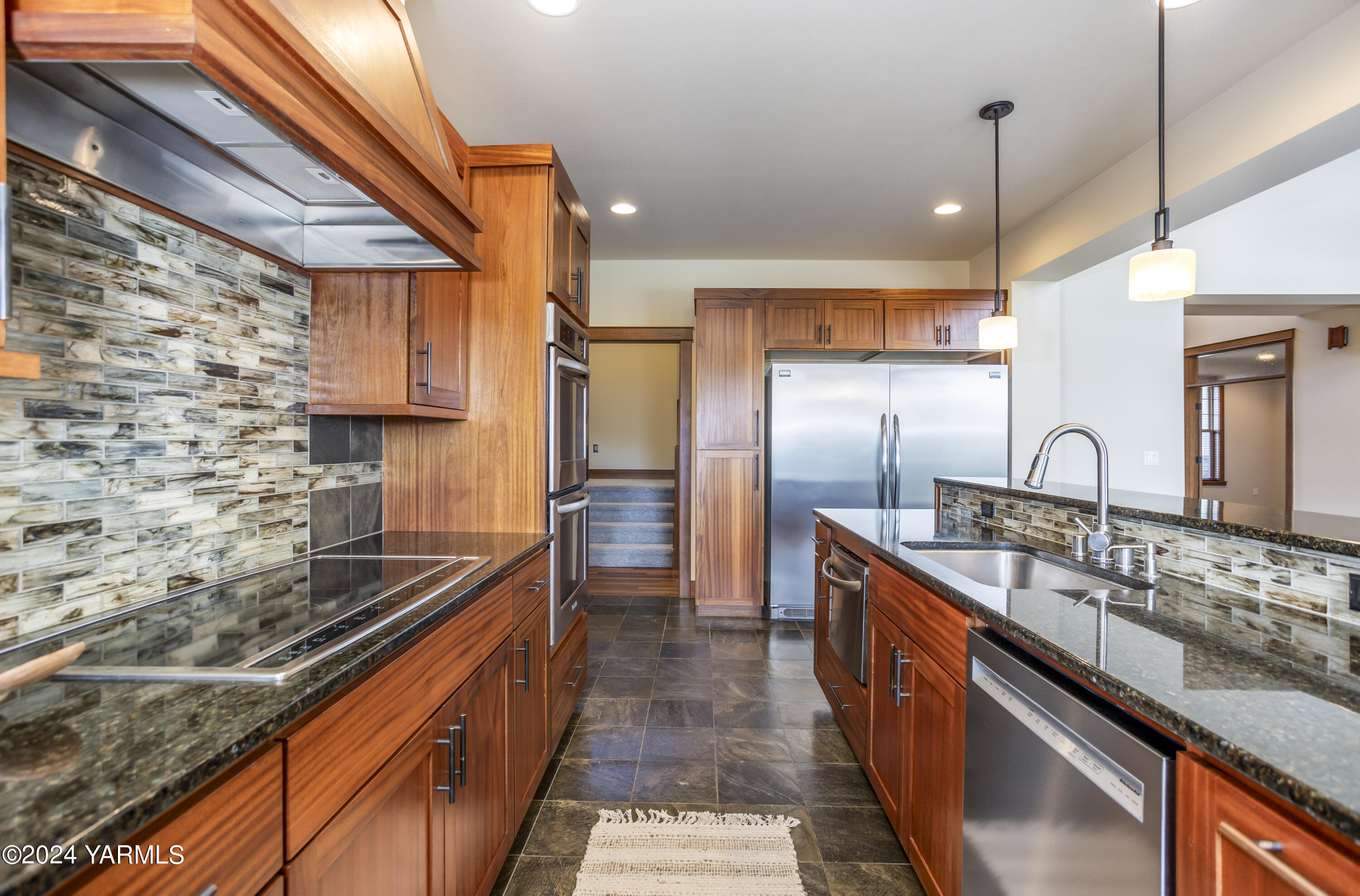 7115 1396 Private Road Southwest Prosser, WA 99350 - Photo 11 of 47 a kitchen with stainless steel appliances granite countertop a sink a stove and a refrigerator