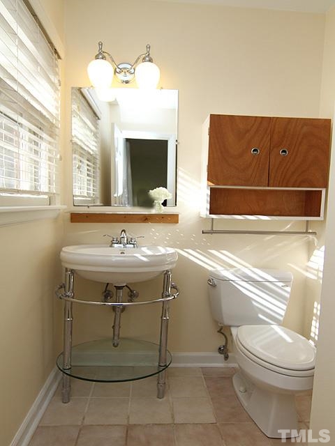 3819 Pickett Road Durham, NC 27705 - Photo 12 of 25 Some nice updates to the master bath. Tile floor, pedestal sink, and modern storage cabinets.