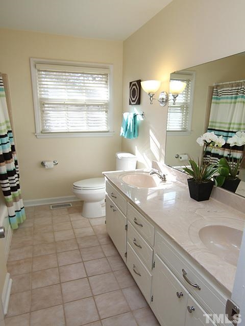 3819 Pickett Road Durham, NC 27705 - Photo 15 of 25 Hall bath includes tiled tub/shower combo, updated fixtures, tile floor, and large linen closet.