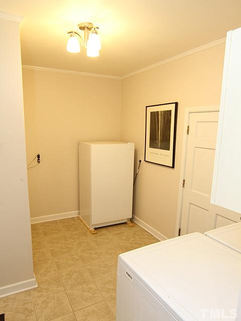 3819 Pickett Road Durham, NC 27705 - Photo 18 of 25 Mudroom is located between the bonus and garage, and includes laundry, a closet, and room for a second fridge or freezer.