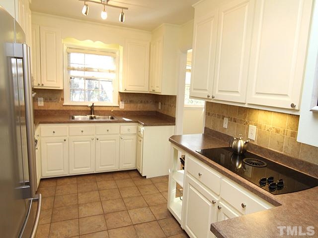 3819 Pickett Road Durham, NC 27705 - Photo 6 of 25 Solid wood cabinets and electric cooktop.