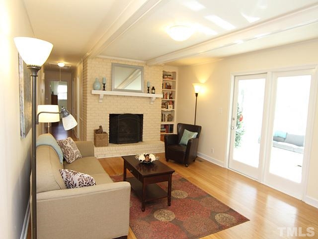 3819 Pickett Road Durham, NC 27705 - Photo 8 of 25 Family room features cozy wood-burning fireplace, and access to sunroom. Cute built-in bookcase too!