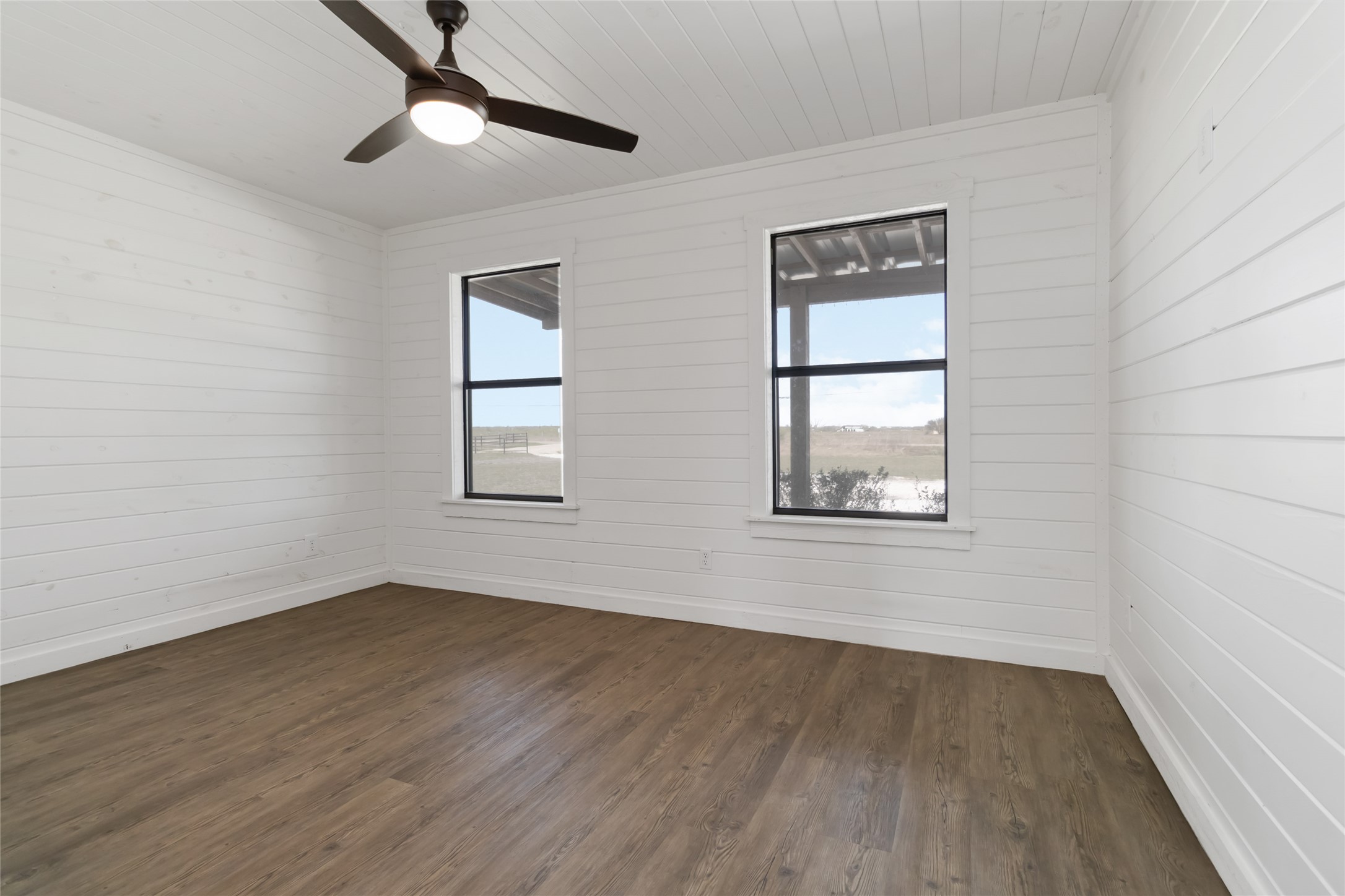 1525 Scull Road San Marcos, TX 78666 - Photo 16 of 25 Spare room with plenty of natural light, wooden ceiling, ceiling fan, and dark wood-style flooring
