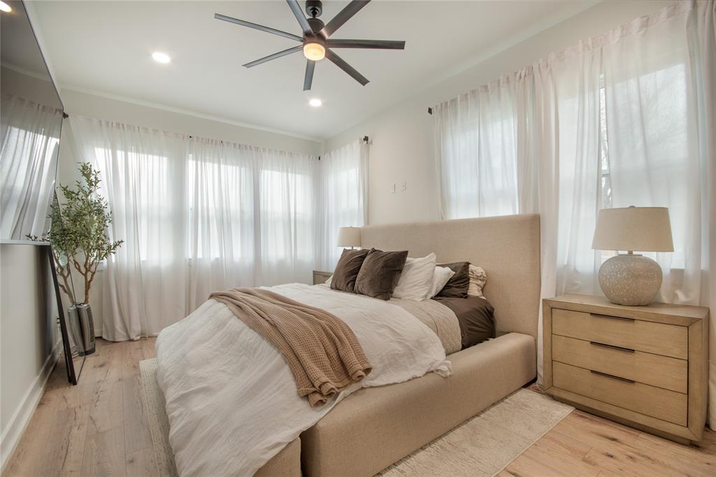 4648 Corregidor Street Dallas, TX 75216 - Photo 11 of 30 a bedroom with a bed and ceiling fan