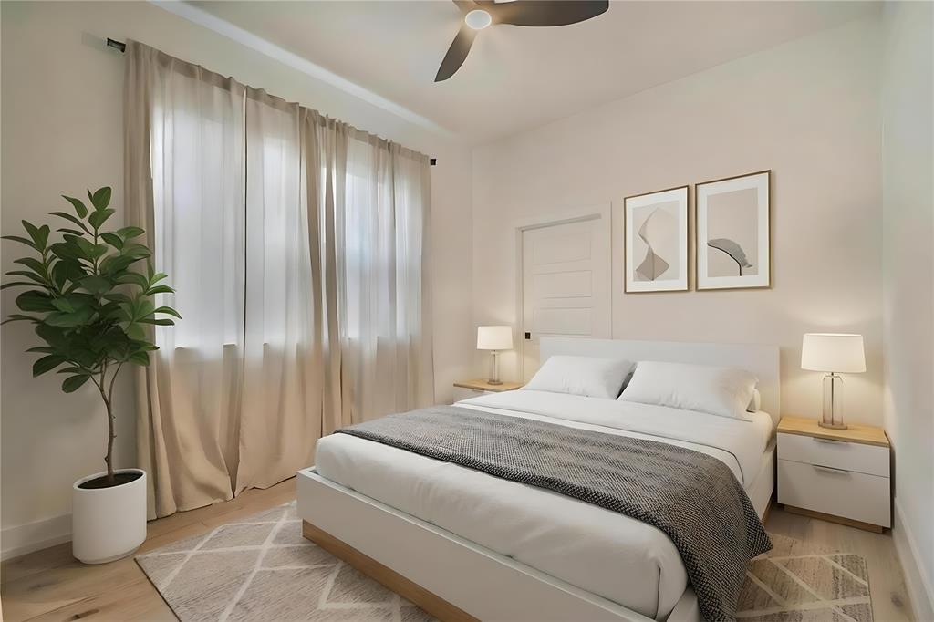 4648 Corregidor Street Dallas, TX 75216 - Photo 15 of 30 a bedroom with a large bed and a potted plant