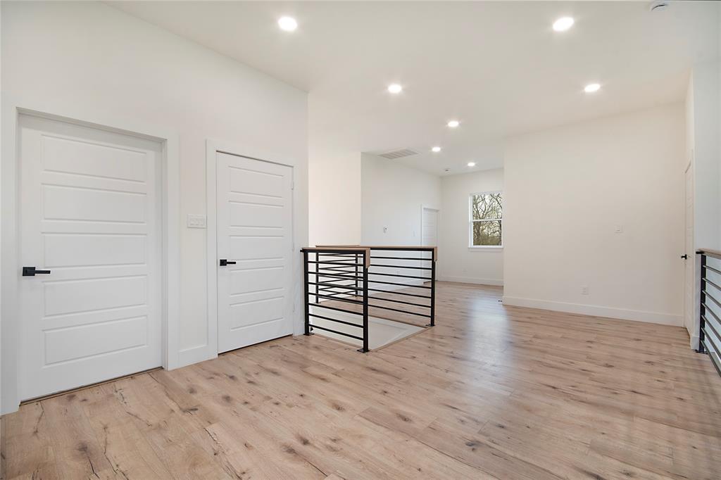 4648 Corregidor Street Dallas, TX 75216 - Photo 18 of 30 a view of an empty room with wooden floor and stairs