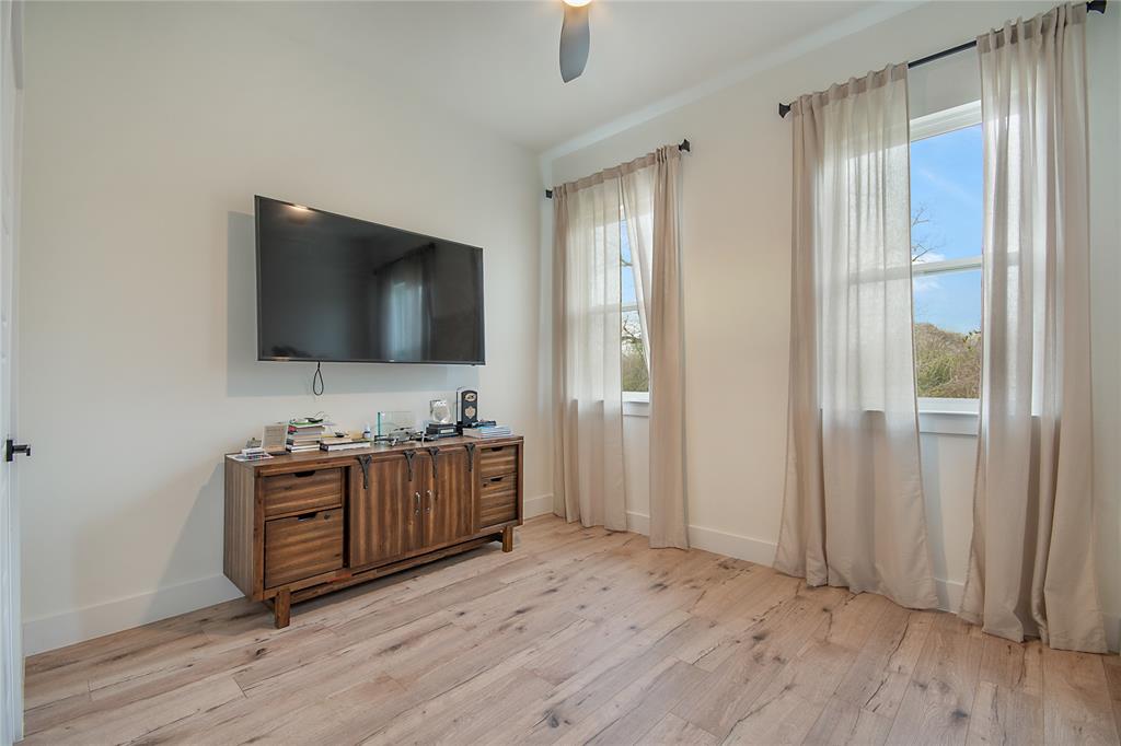 4648 Corregidor Street Dallas, TX 75216 - Photo 26 of 30 a living room with furniture and a flat screen tv