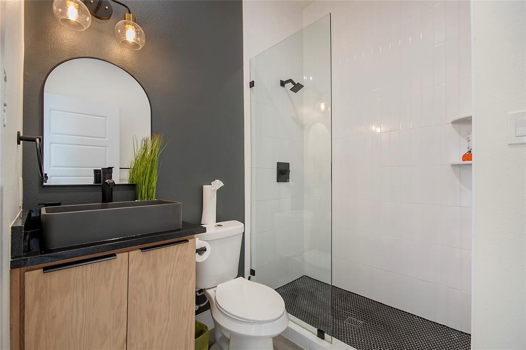 4648 Corregidor Street Dallas, TX 75216 - Photo 4 of 30 a bathroom with a toilet sink and mirror