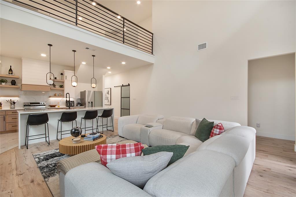 4648 Corregidor Street Dallas, TX 75216 - Photo 6 of 30 a living room with furniture kitchen view and a chandelier