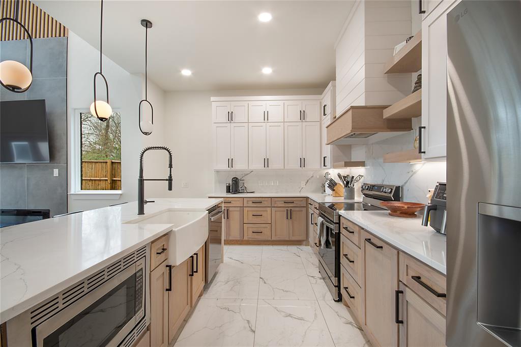 4648 Corregidor Street Dallas, TX 75216 - Photo 9 of 30 a kitchen with a sink stove and cabinets
