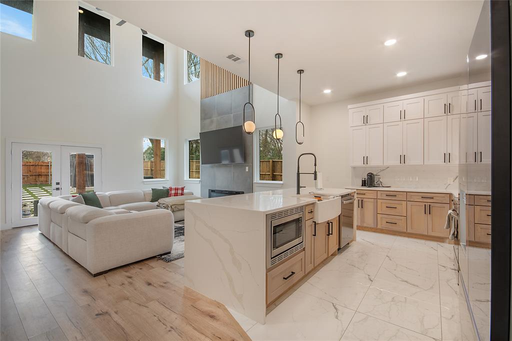 4648 Corregidor Street Dallas, TX 75216 - Photo 10 of 30 a large white kitchen with cabinets and stainless steel appliances