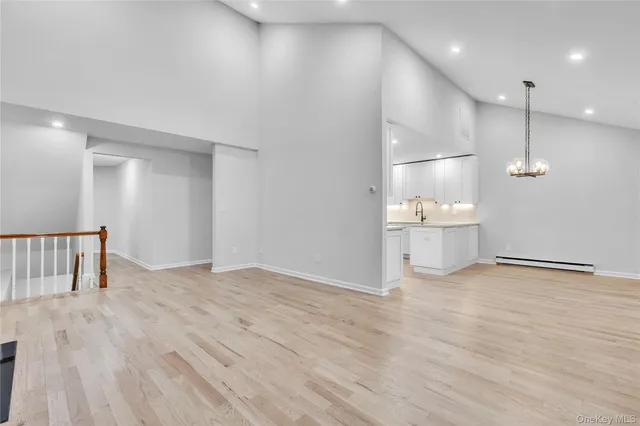 a view of a kitchen with a sink and wooden floor