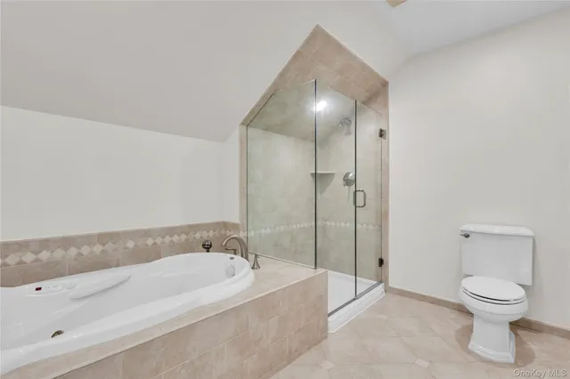 a spacious bathroom with a bathtub and toilet