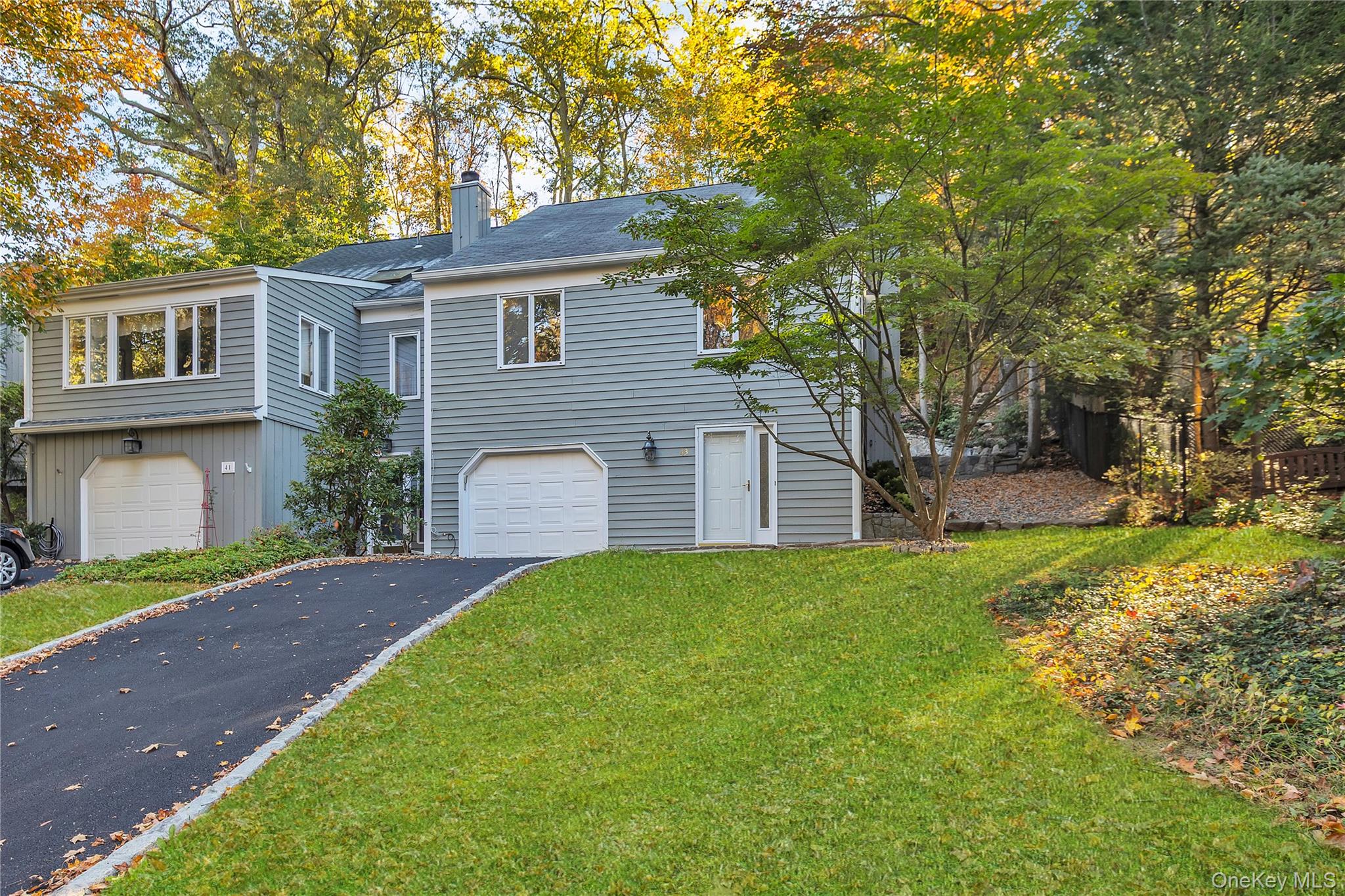 43 Park Road Goldens Bridge, NY 10526 - Photo 2 of 27 a front view of a house with a yard and garage