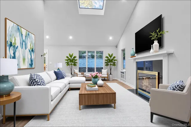 a living room with furniture a flat screen tv and a fireplace