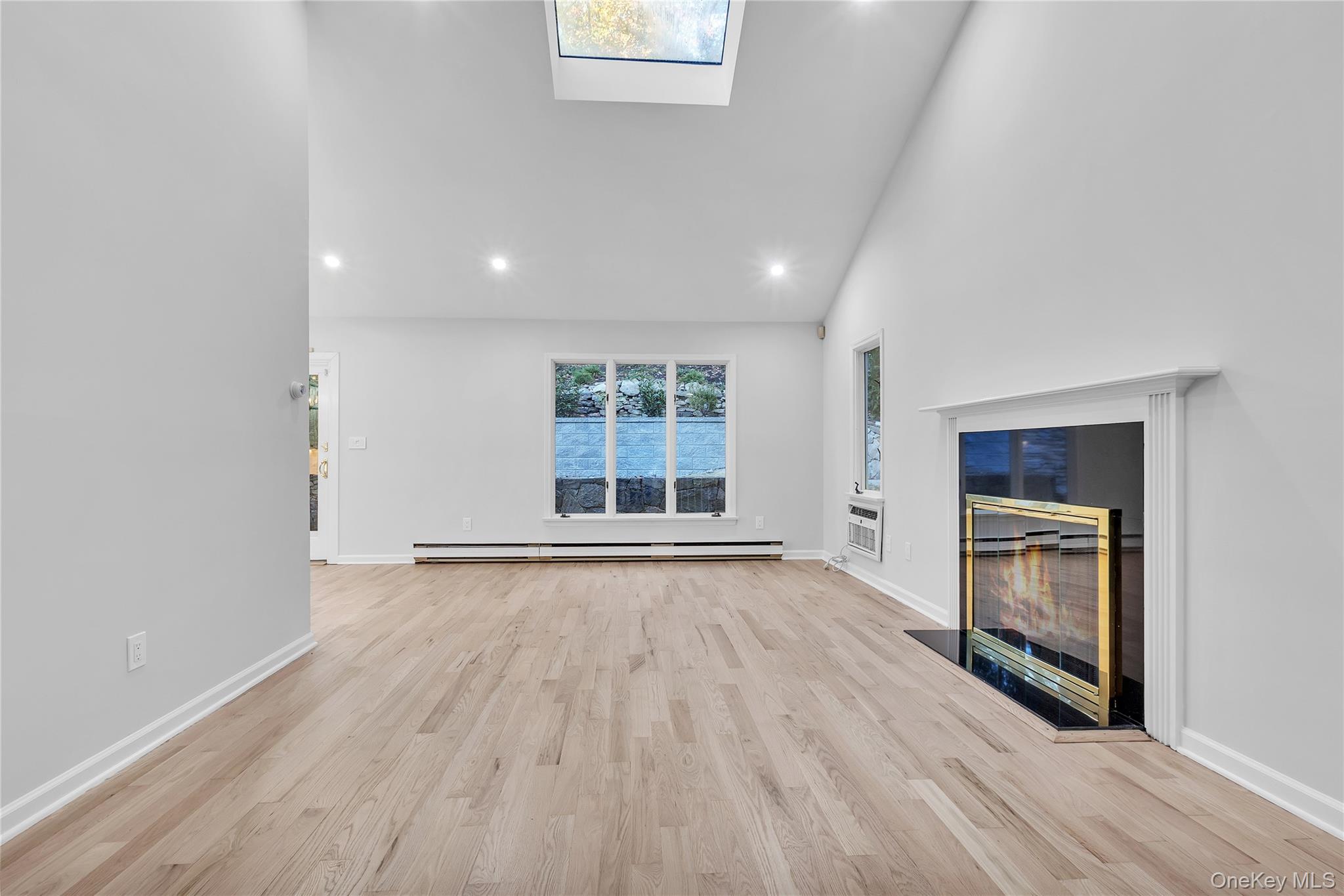 43 Park Road Goldens Bridge, NY 10526 - Photo 4 of 27 an empty room with wooden floor and windows