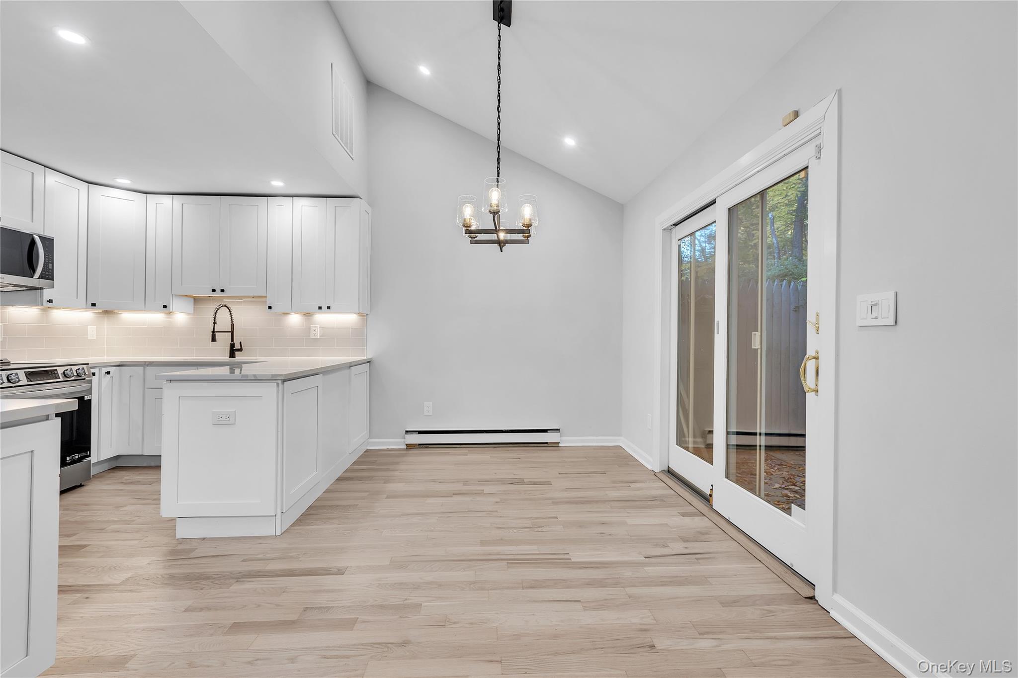 43 Park Road Goldens Bridge, NY 10526 - Photo 7 of 27 a large white kitchen with a sink and dishwasher with wooden floor