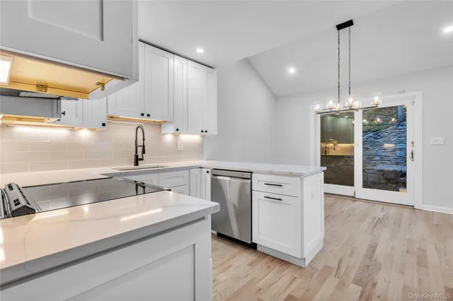 a kitchen with a sink stainless steel appliances and cabinets