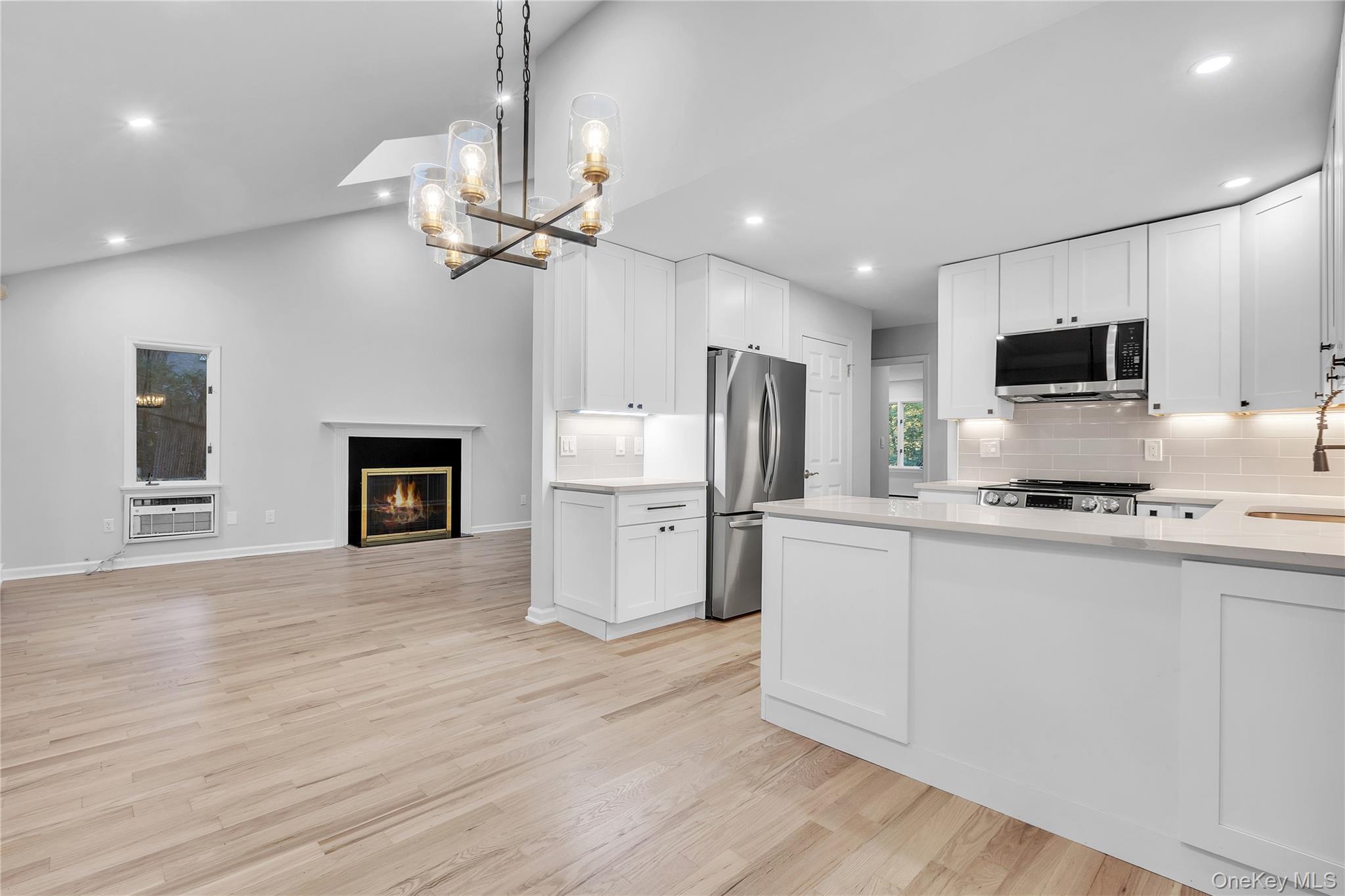 43 Park Road Goldens Bridge, NY 10526 - Photo 10 of 27 a kitchen with stainless steel appliances a stove top oven a refrigerator cabinets and a chandelier