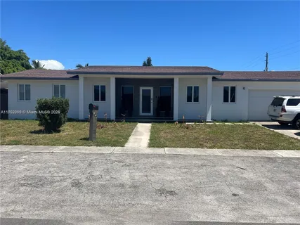 a view of a yard in front view of a house
