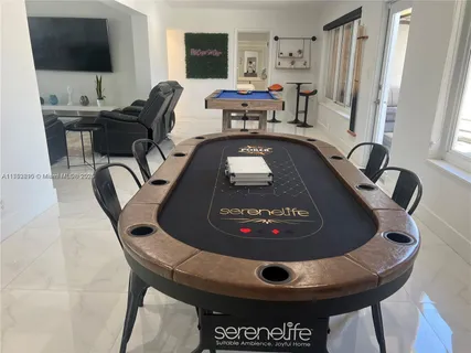a view of a livingroom with workspace and a window