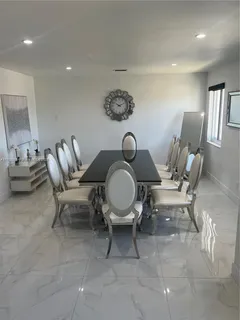 a living room with furniture and a mirror