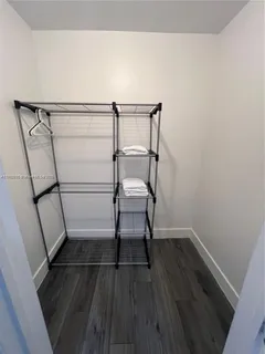 a room with a bench and wooden floor