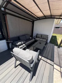 a view of roof deck with wooden floor and seating space