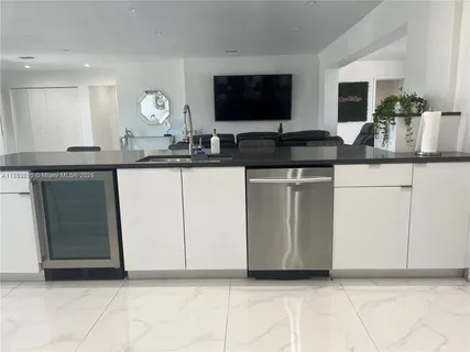 a kitchen with granite countertop a sink and a stove top oven