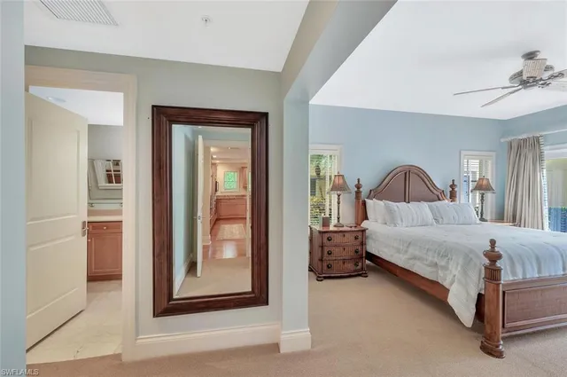 a bedroom with a bed and a mirror