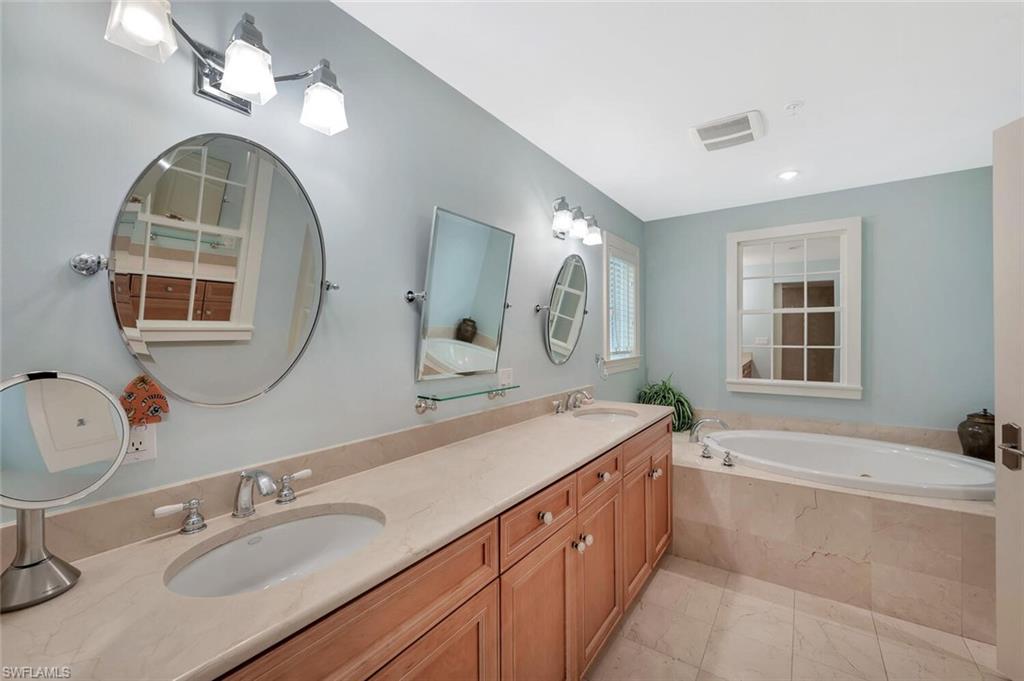 325 3rd Street South, Unit 6 Naples, FL 34102 - Photo 20 of 36 a spacious bathroom with a granite countertop double vanity sink a mirror and a bathtub